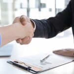 two people are shaking their hand, as an agreement is formed.